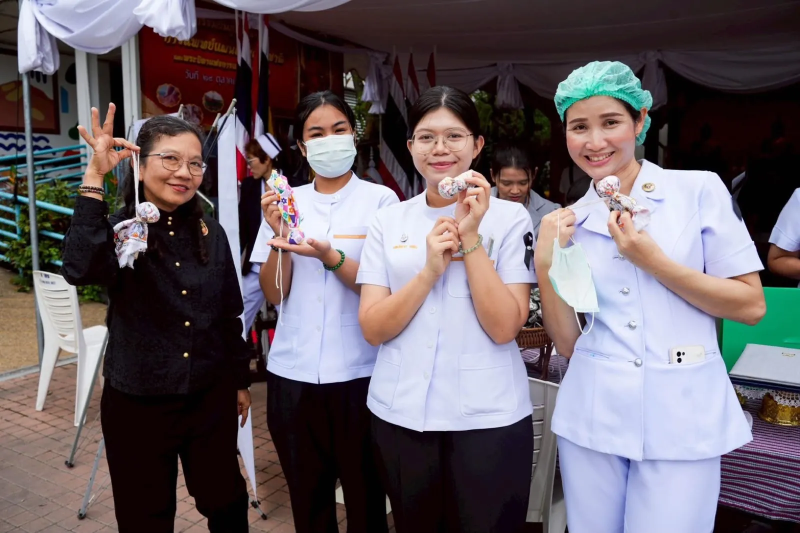 The team with herbal compresses and scented sachets at an exhibition